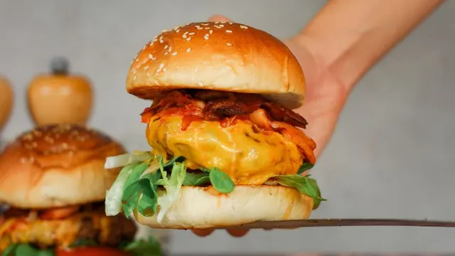 A burger stacked with lettuce and cheese