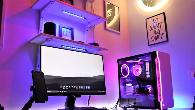 A desk with a computer and colorful lighting